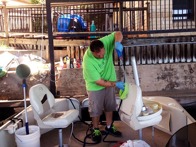Justin Holcomb of Eco Steam Car Wash & Detailing cleaning a boat seat with the Optima Steamer