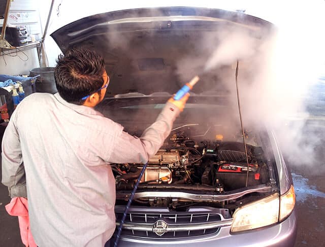 Steam cleaning the engine bay of a car
