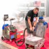 Demonstration of Contigo Pro Steamer cleaning a car seat at a trade show
