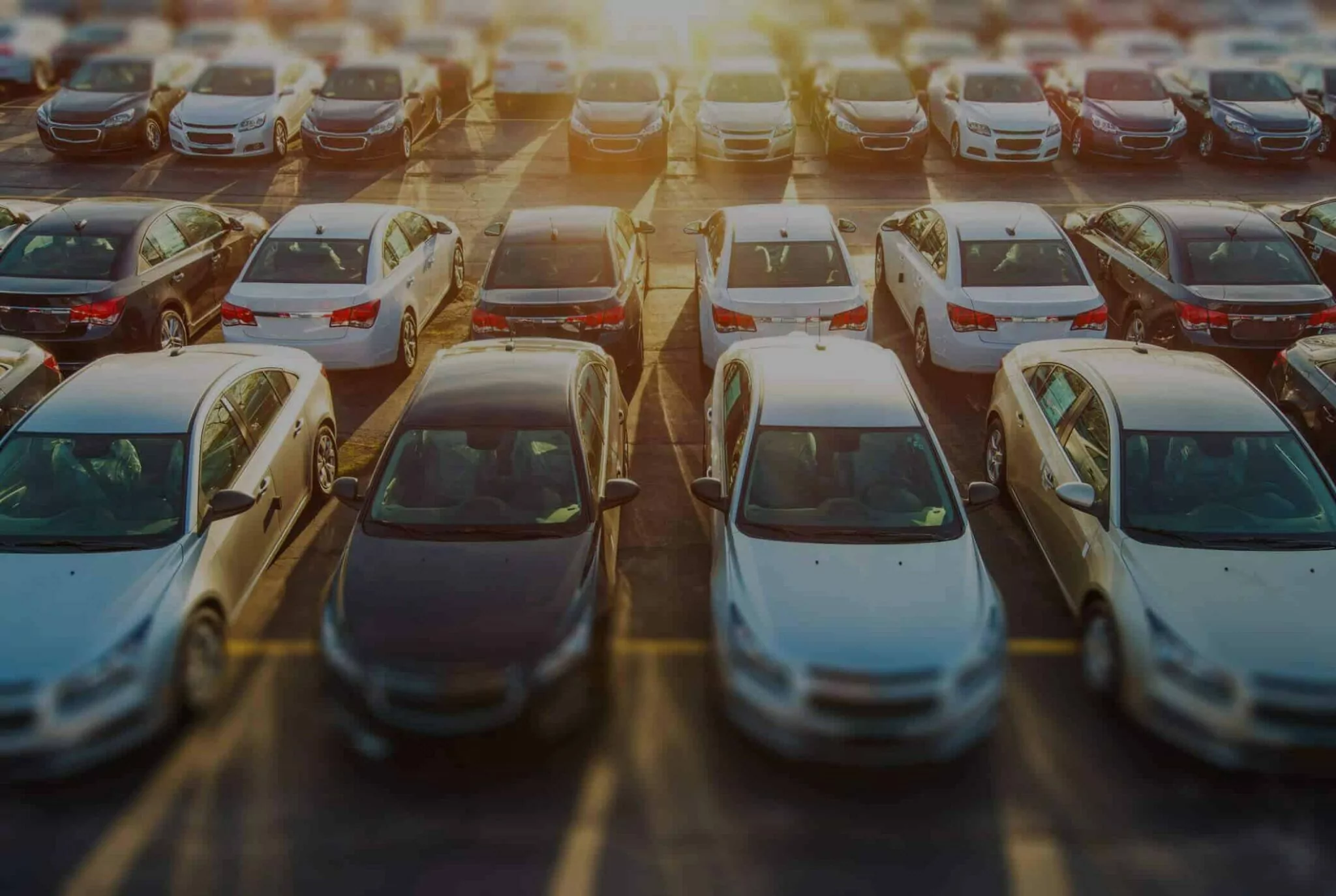 Overhead view of a fleet of vehicles in a large parking lot